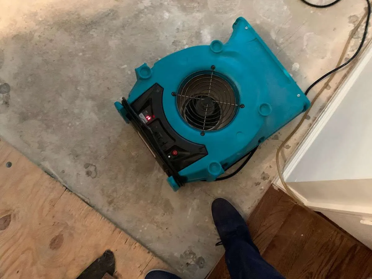 Air mover drying subfloor during Commercial Water Damage Restoration in Olathe